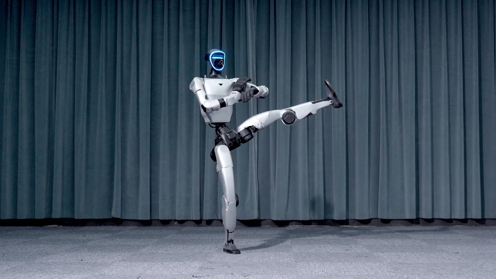 Unitree G1 holding a high kick during a demonstration